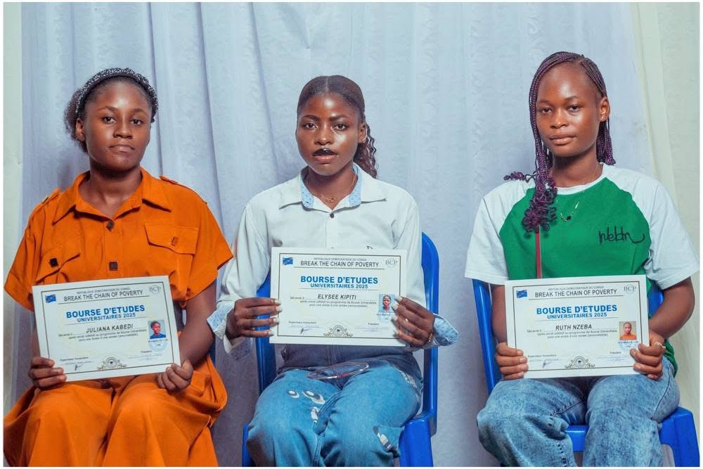 Three people holding university scholarship certificates
