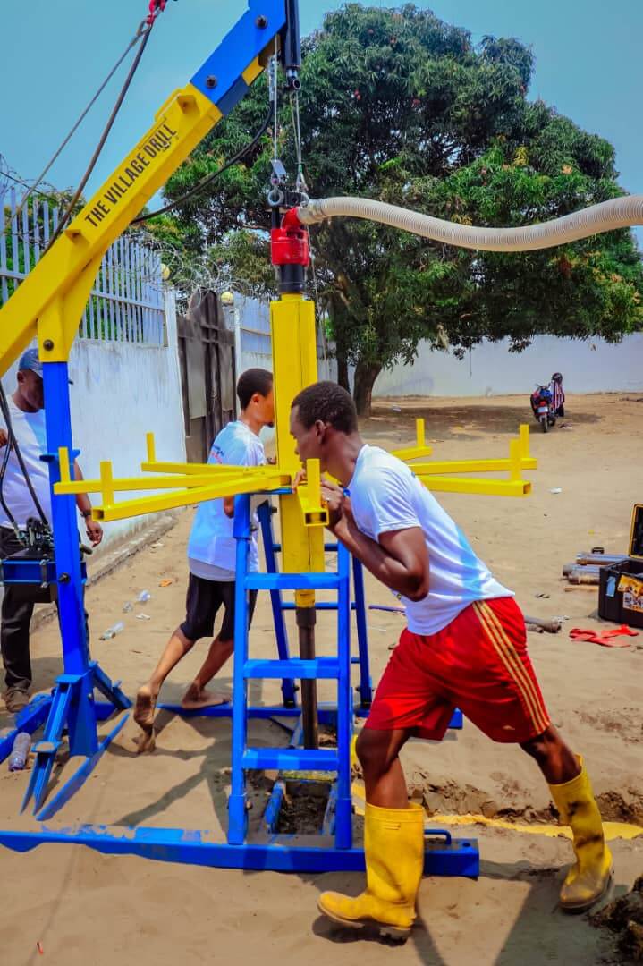 Community members operating a Village Drill to reach a safe water source